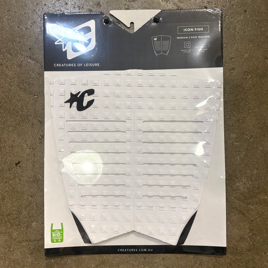 Packaged surfboard fin with visible branding on a textured surface