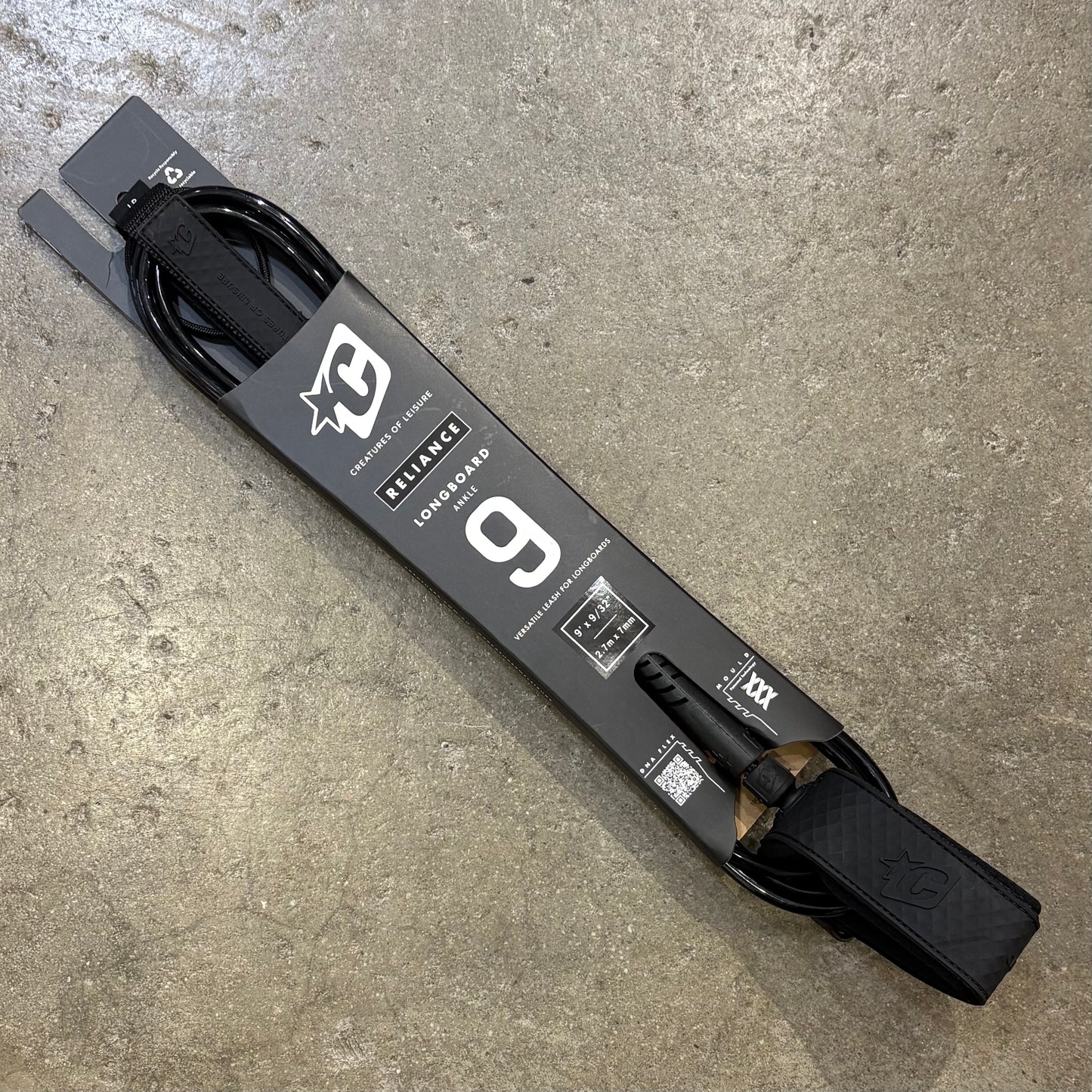 Longboard with a visible brand logo on a concrete surface