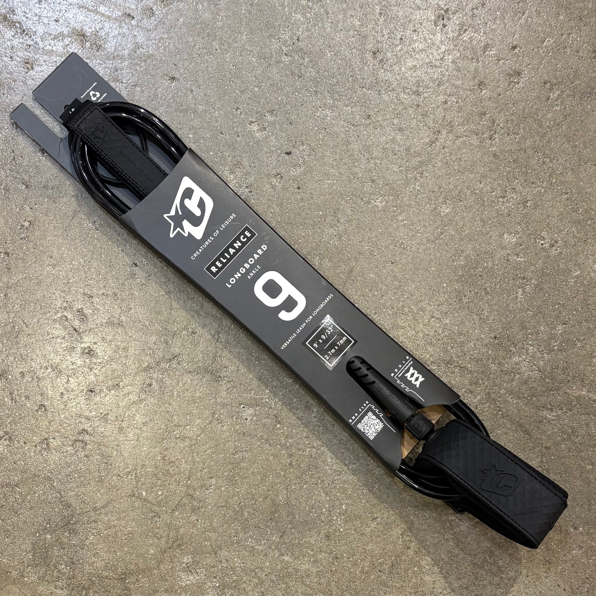 Longboard with a visible brand logo on a concrete surface