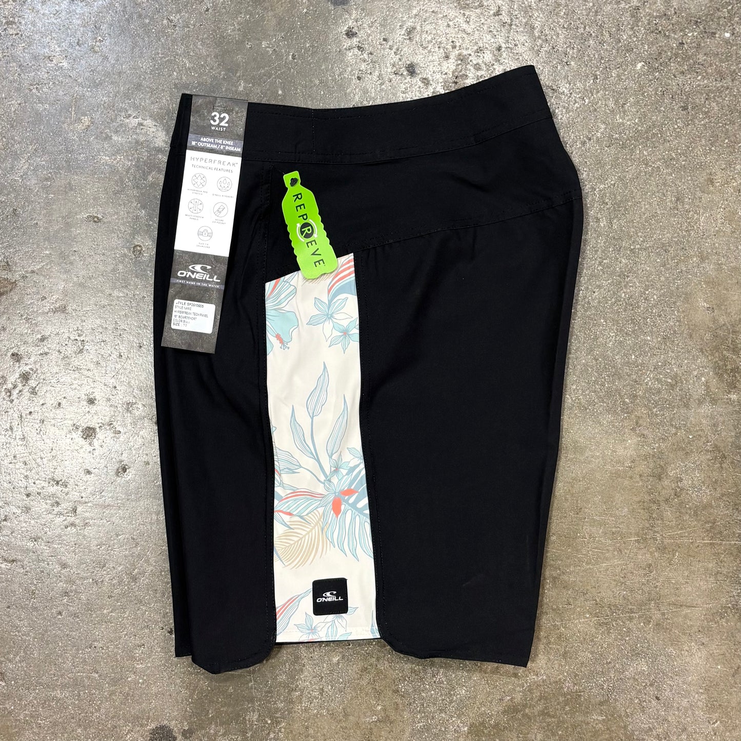 Black pants with tags on a concrete surface