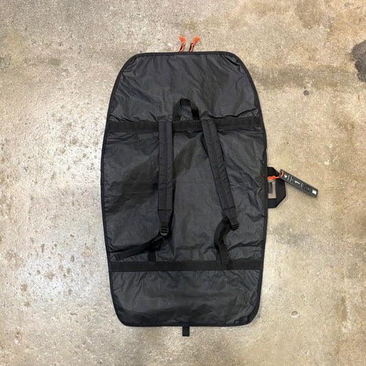 Black bag with orange straps on a concrete surface
