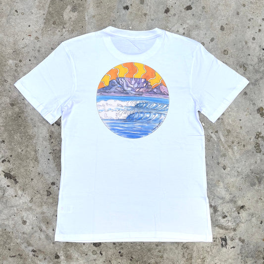 White t-shirt with a colorful graphic of a mountain and sunset on a concrete surface