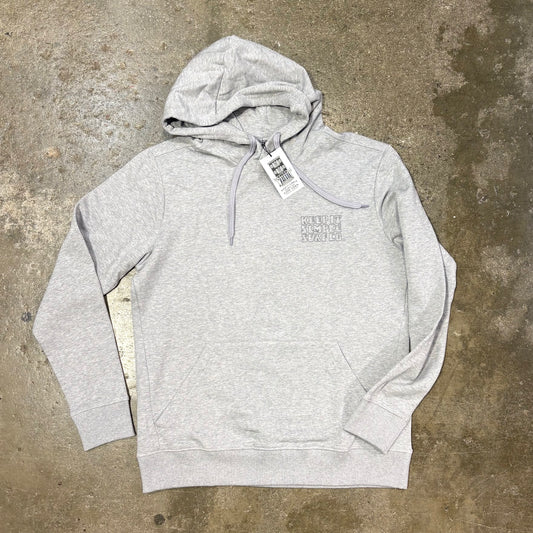 Gray 'Keep it simple surf' hoodie with a tag on a concrete surface