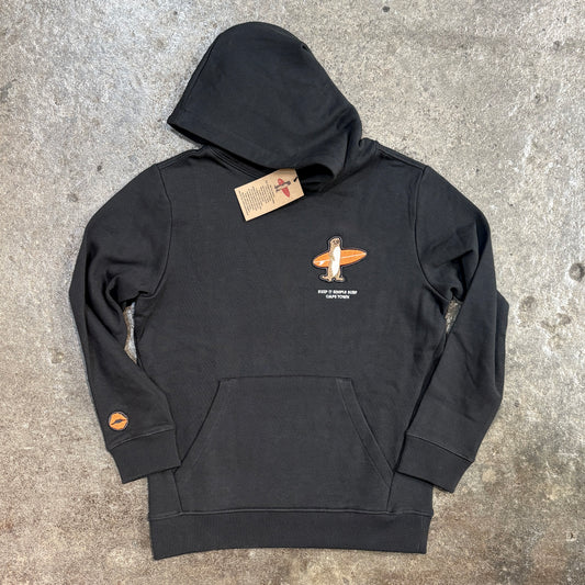 A black pullover hoodie laid flat on a textured concrete surface, featuring a small orange and white graphic on the left chest with the text 'JACKIE DOUGLAS WALKER SURFER' and a small orange circular patch on the right sleeve.