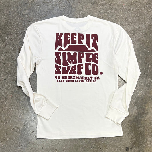 White long-sleeve shirt with maroon text on a gray concrete surface