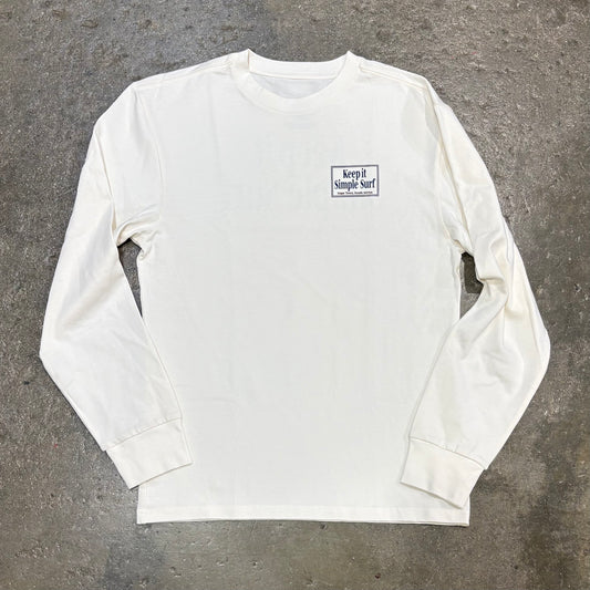 White long-sleeve shirt with a logo on a gray concrete surface