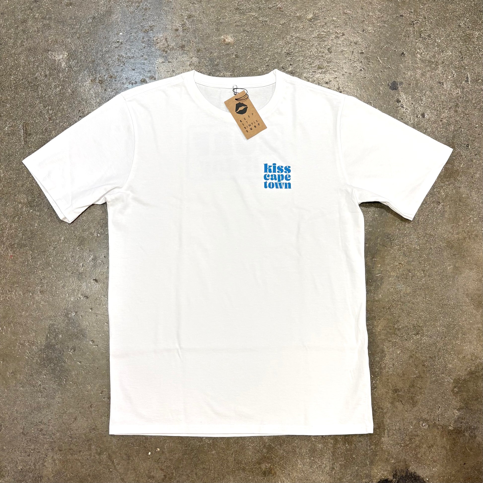 White t-shirt with  Kiss Cape Town Logo on a textured gray surface