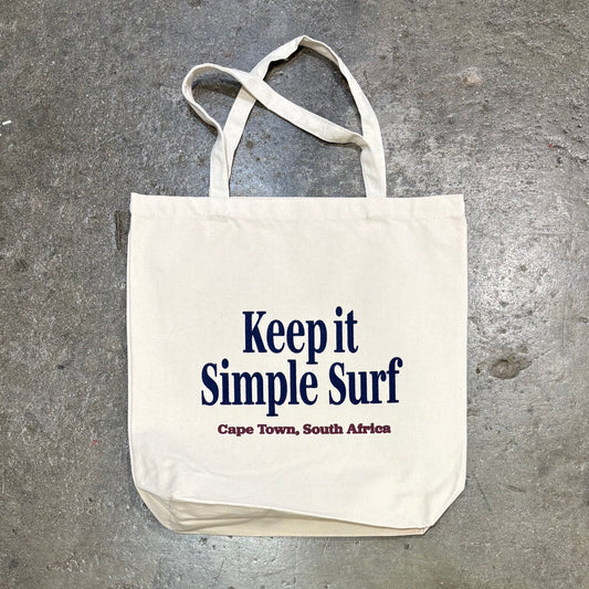 KISS Tote Bag - Rectangle - on a concrete surface