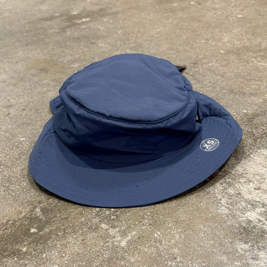 A blueOcean & Earth surf hat with a stiff peak on a concrete floor