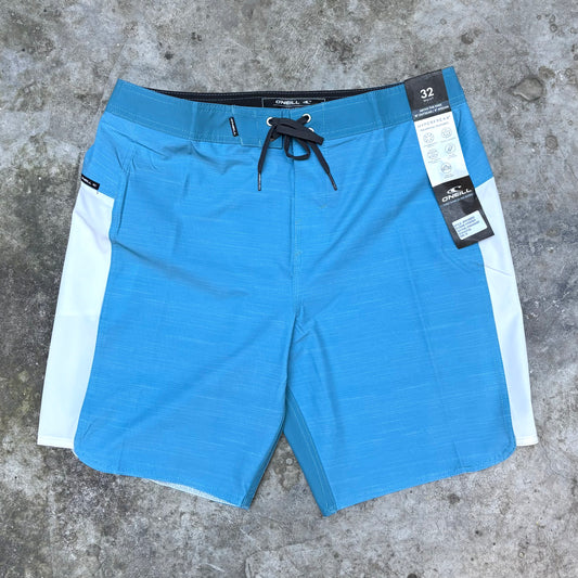 Blue shorts with a white stripe on a concrete surface