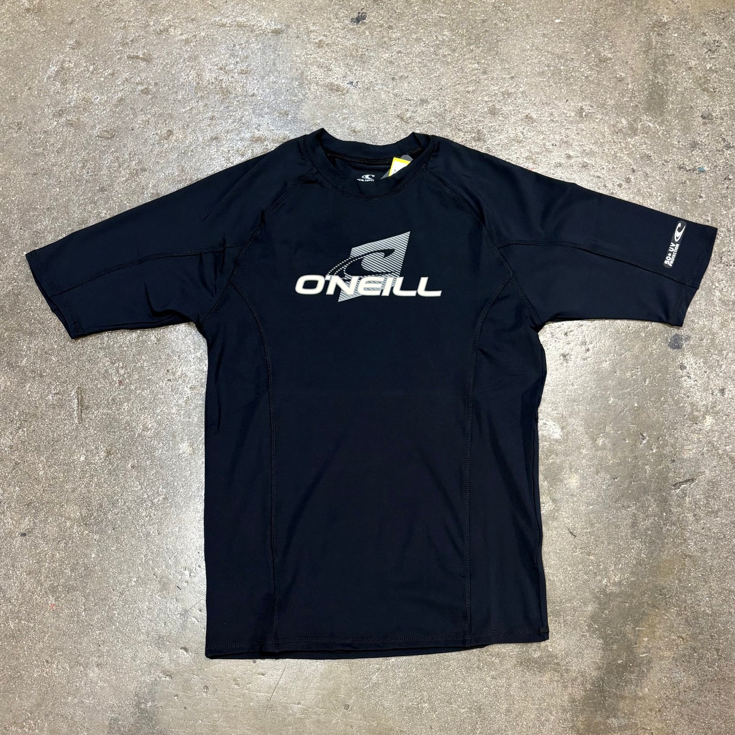 Black long-sleeve shirt with O'Neill logo on a concrete surface