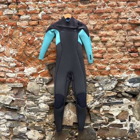 Black and teal O'Neill Hyperfreak wetsuit hanging on a brick wall.