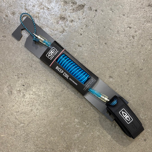Black and blue device labeled 'Bicep Coil' on a concrete surface