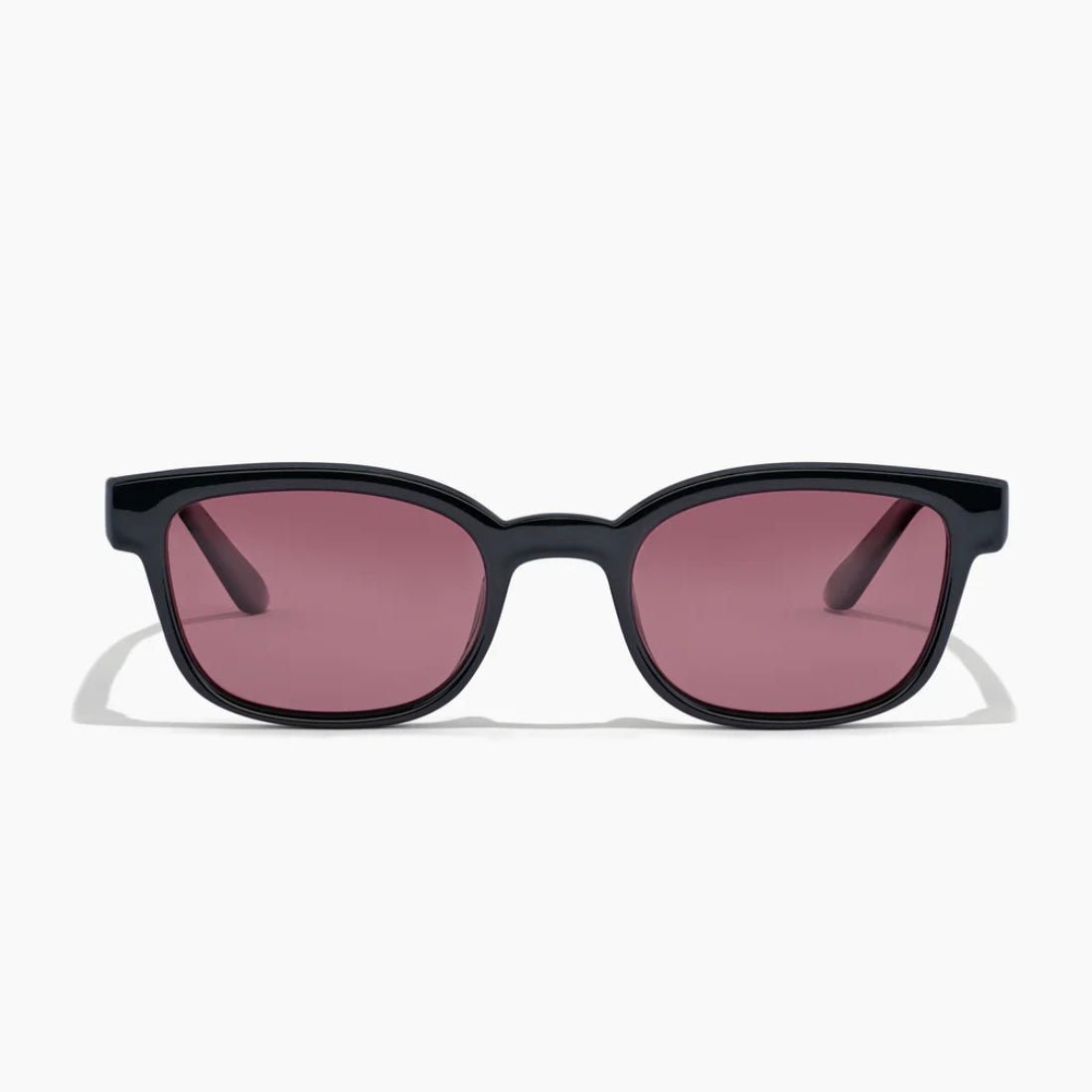 Black sunglasses with pink lenses on a white background