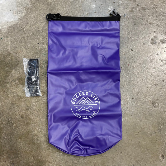 Purple dry bag with 'Rugged Life' logo on a concrete surface