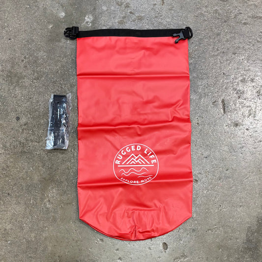 Red dry bag with 'Rugged Life' logo on a concrete surface