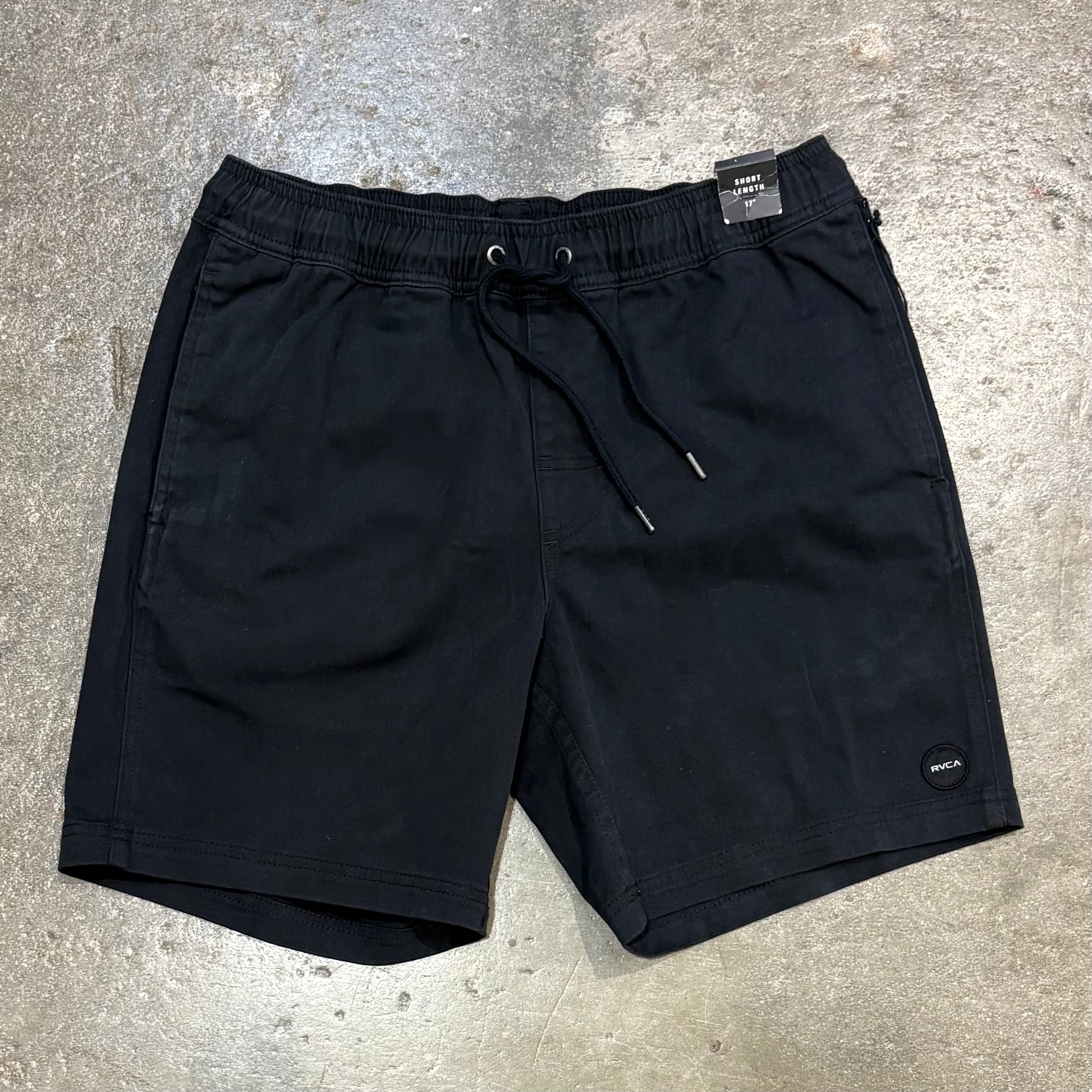 Black shorts on a gray concrete surface
