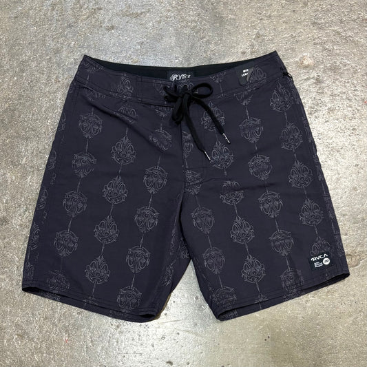 Black shorts with a pattern on a gray concrete surface