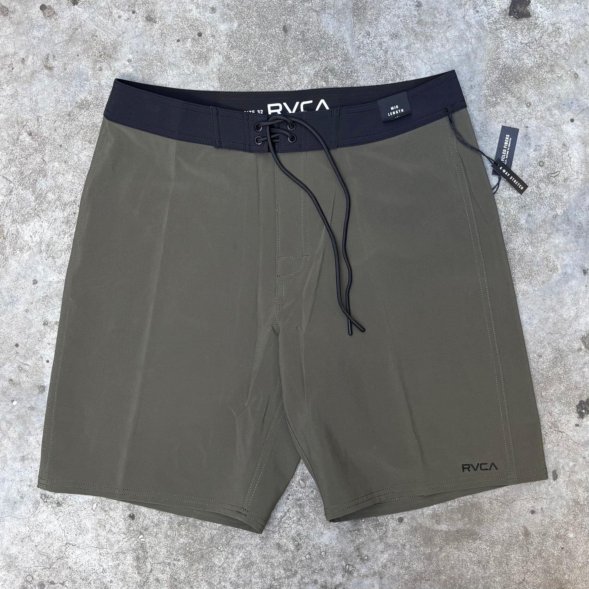 Green RVCA Boardshort on concrete surface.