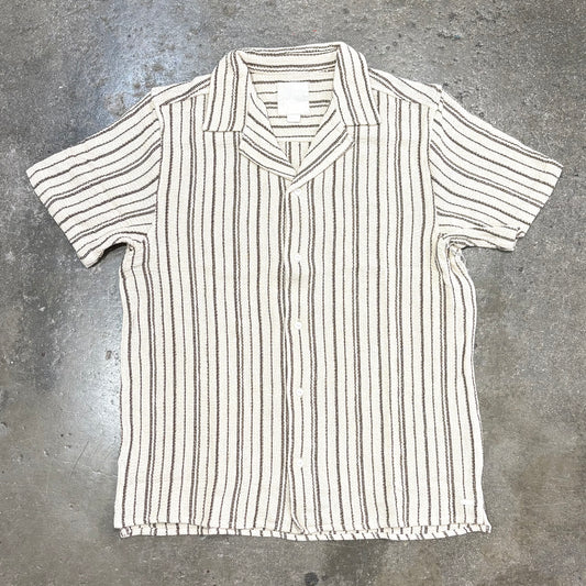 Striped shirt on a gray concrete surface