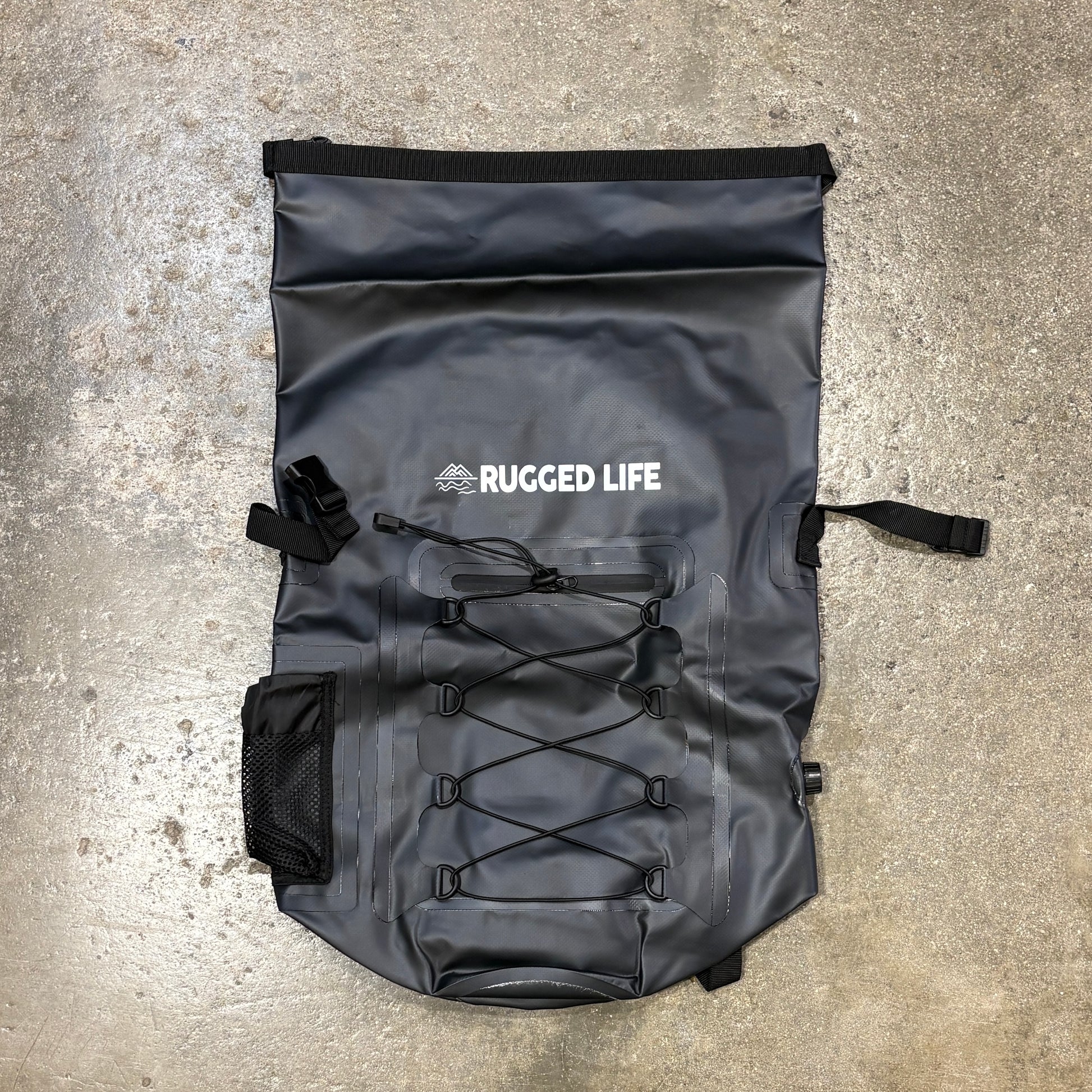 Rugged Life Dry & Compression Bag Backpack  in Heavy Duty Black on a concrete floor