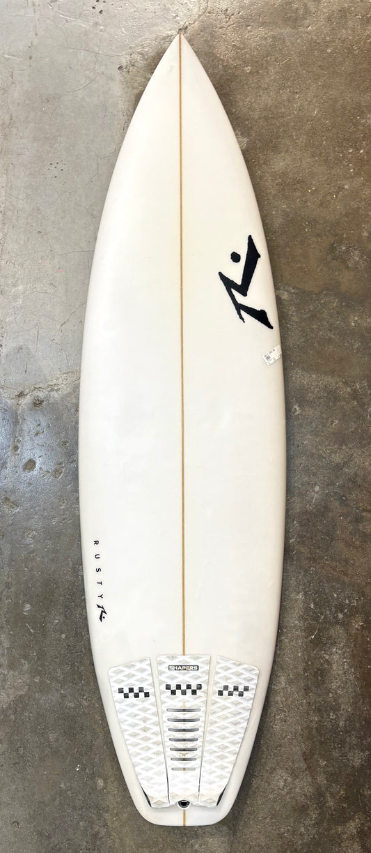 White surfboard with a logo on a textured gray surface