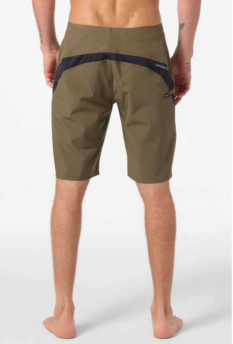 Person wearing olive green shorts with a visible brand logo on a white background