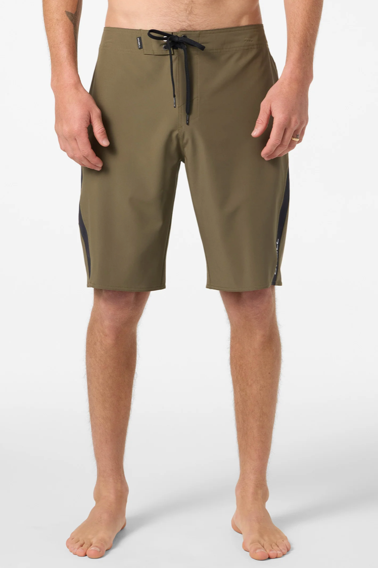 Person wearing olive green shorts with black accents on a white background