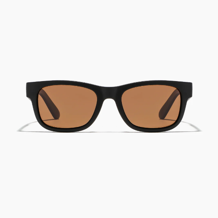Black sunglasses with brown lenses on a white background