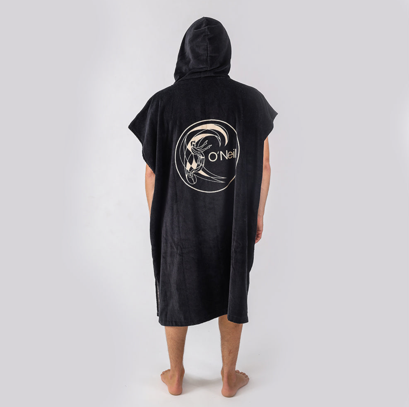 Person wearing a black hooded towel with a logo on the back against a white background