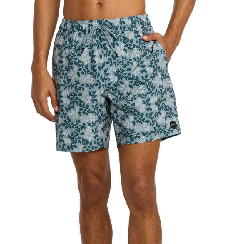 Person wearing blue floral-patterned swim shorts on a white background