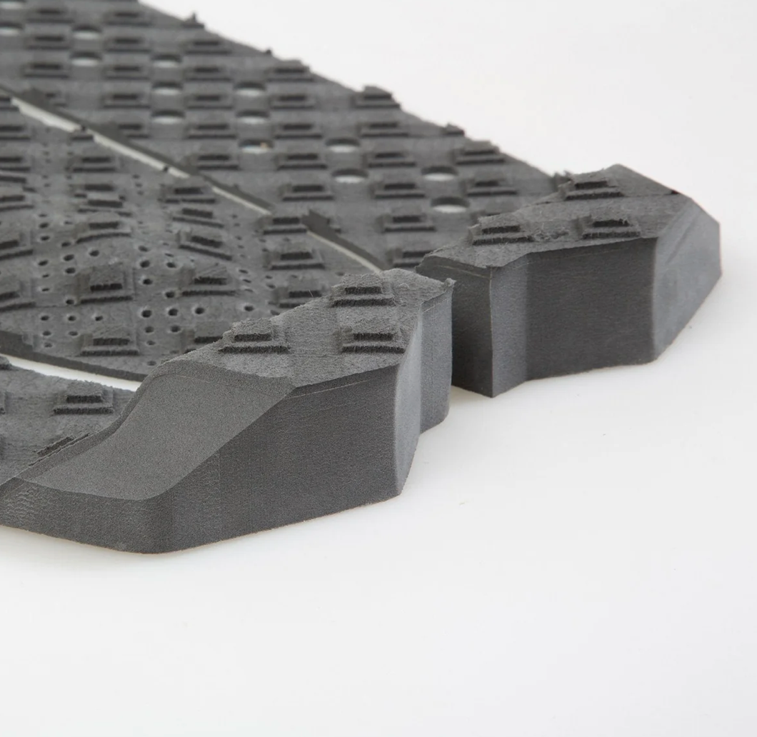 Close-up of a gray rubber mat with textured surface on a white background