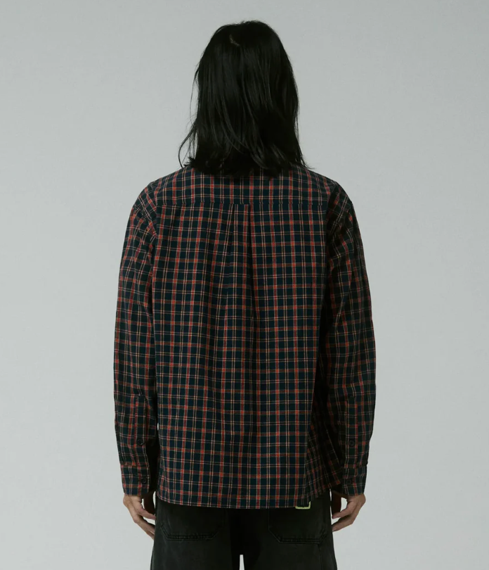 Person wearing a plaid shirt with a plain background