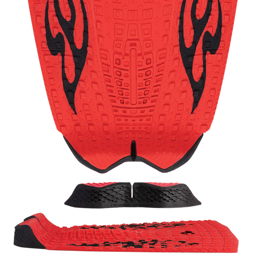 Red and black textured surface with tribal patterns on a white background