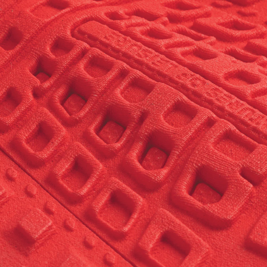 Close-up of a red textured surface with geometric patterns