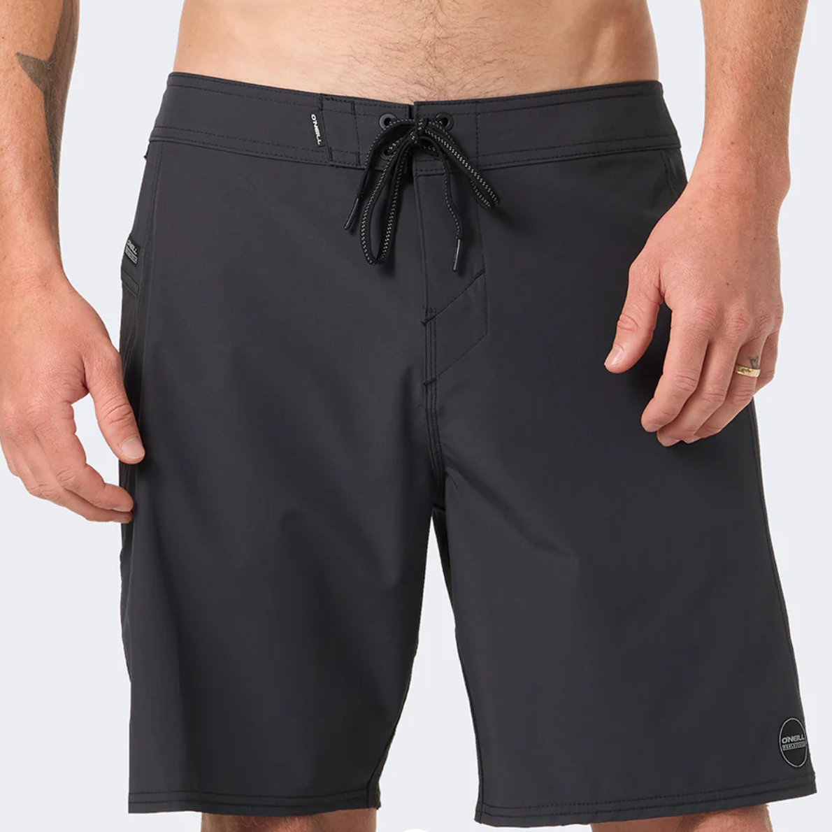 Black shorts worn by a person on a white background