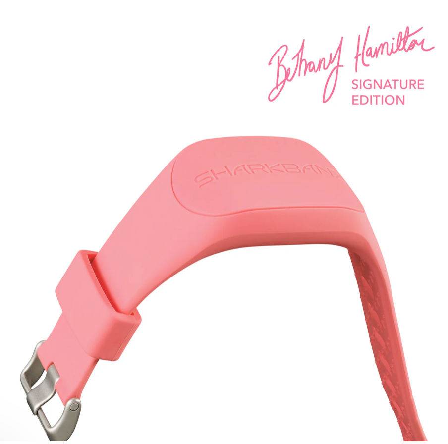 Pink dog collar with 'Shark Bite' logo on a white background, featuring Bethany Hamilton's signature.