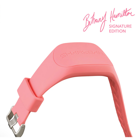 Pink dog collar with 'Shark Bite' logo on a white background, featuring Bethany Hamilton's signature.