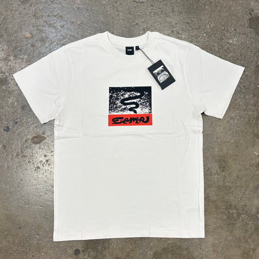 White T-Shirt with logo on concrete surface