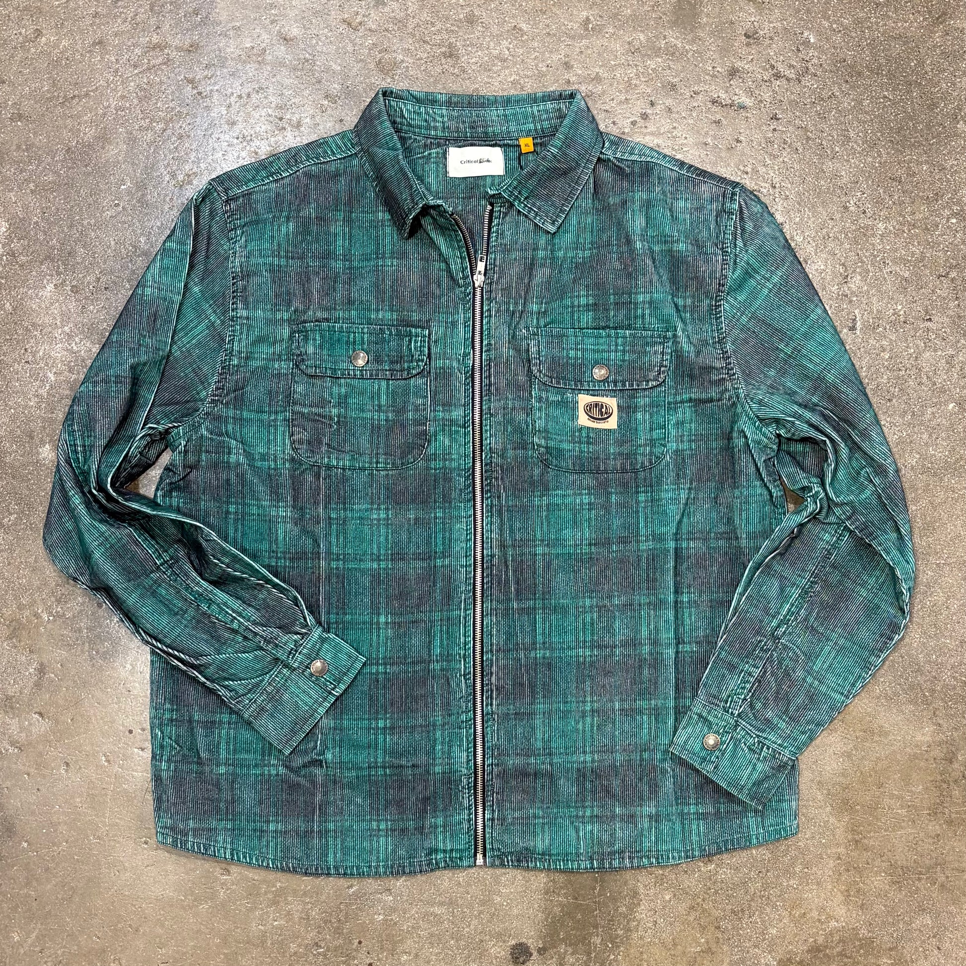 Green plaid shirt on a concrete surface