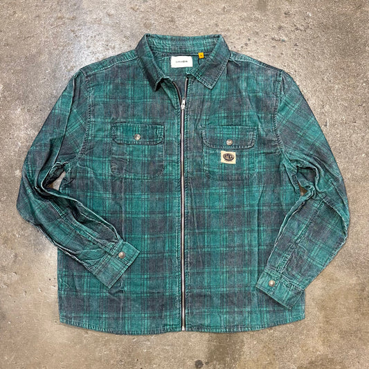 Green plaid shirt on a concrete surface
