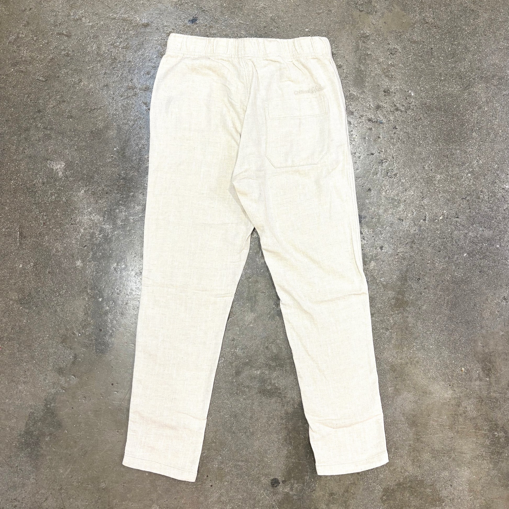 White pants on a gray concrete floor