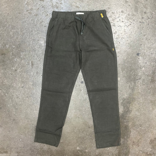 Dark green pants on a concrete floor