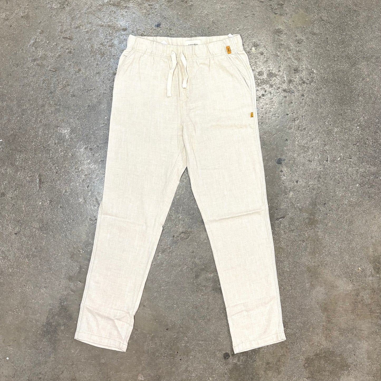 White pants on a gray concrete floor
