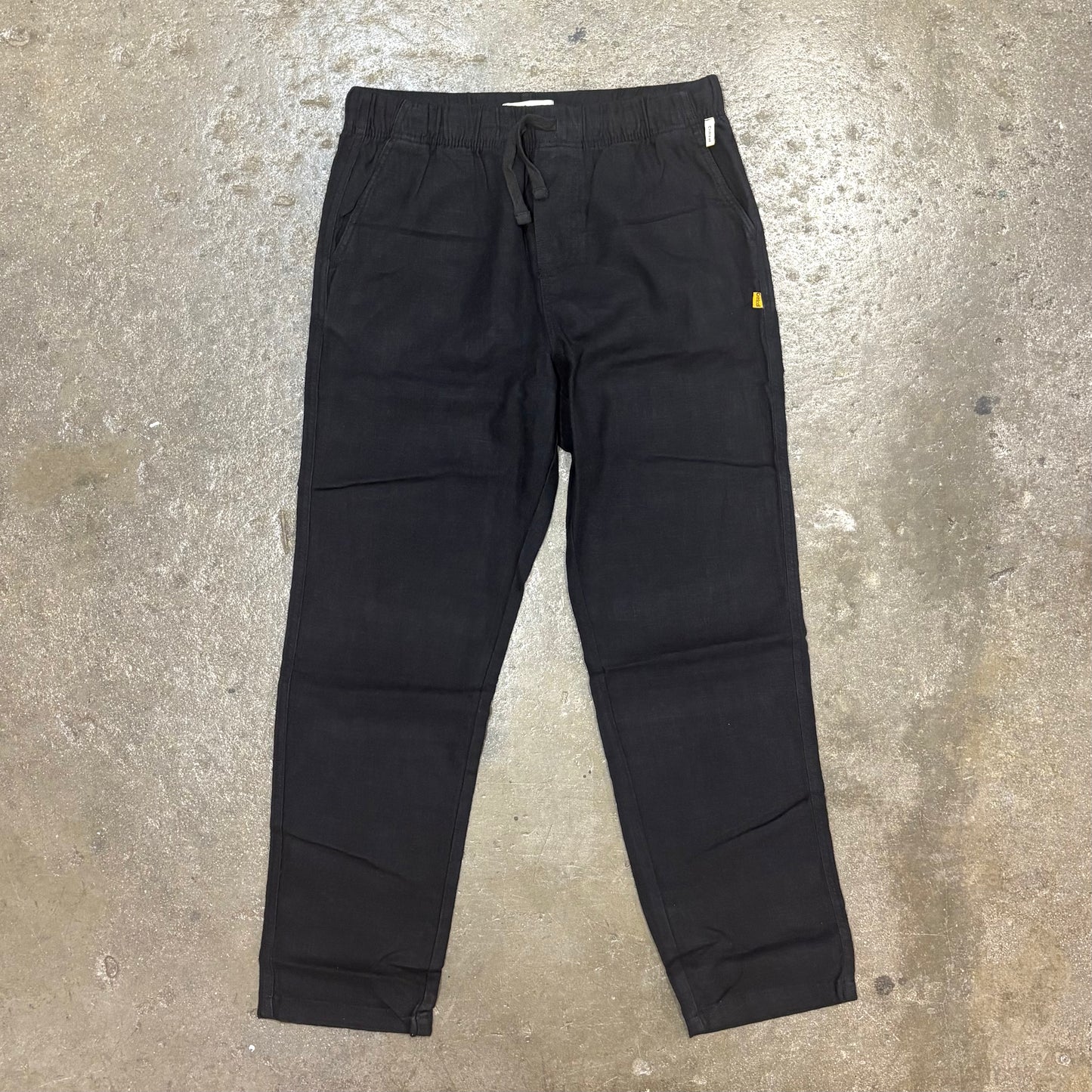 Black pants on a textured gray surface