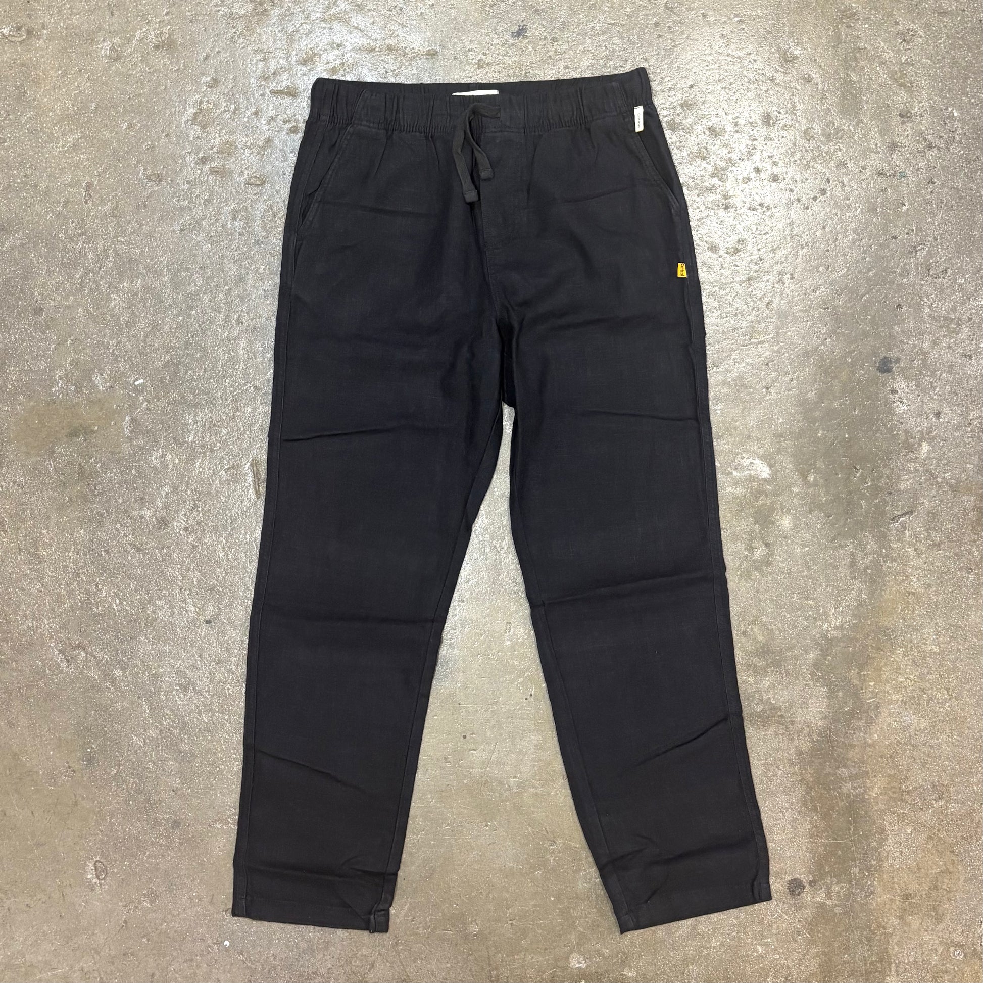 Black pants on a textured gray surface