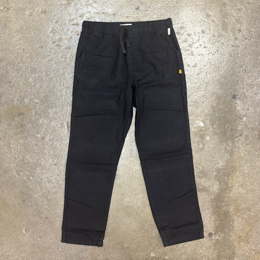 Black pants on a textured gray surface