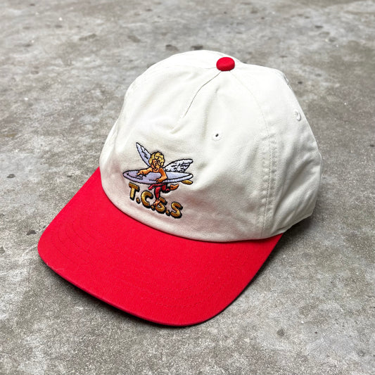 White and red cap with a logo on a concrete surface
