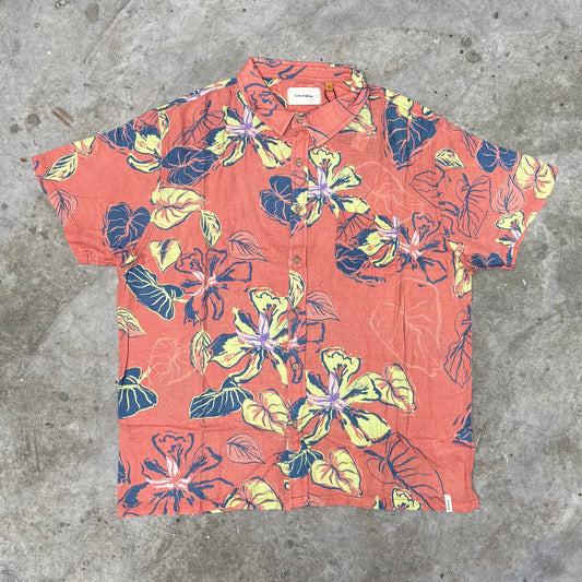 Hawaiian shirt with floral pattern on a concrete surface