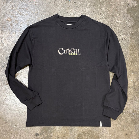 Black long-sleeve shirt with 'Critical' logo on a concrete surface